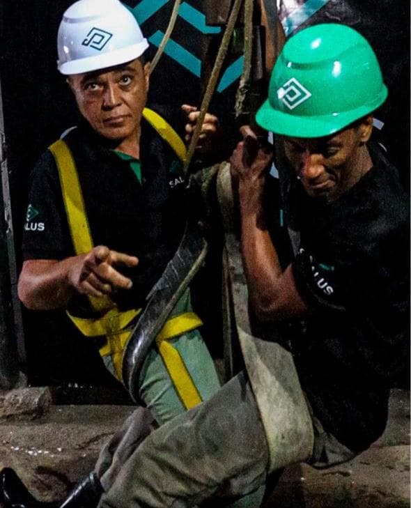 Salus crew descending the shaft, in harness and helmet